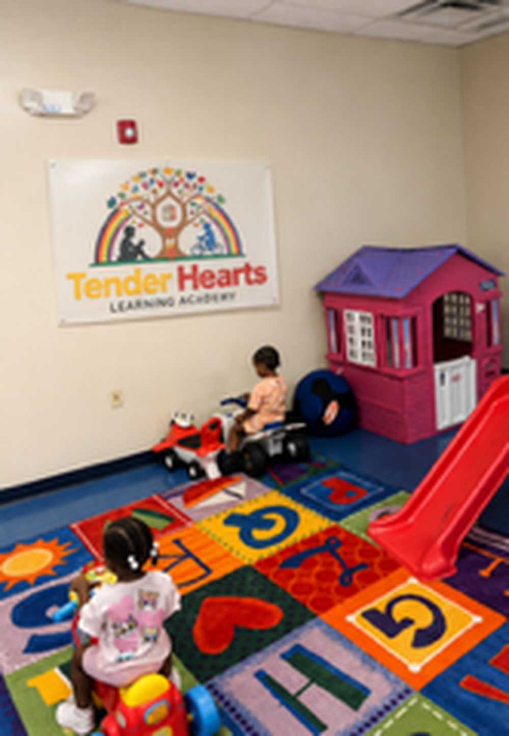 Tender Hearts play room with toys and learning rug